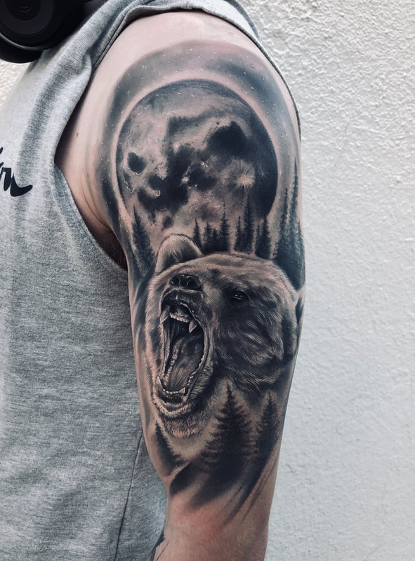 Black and grey realistic bear and moon half sleeve tattoo.