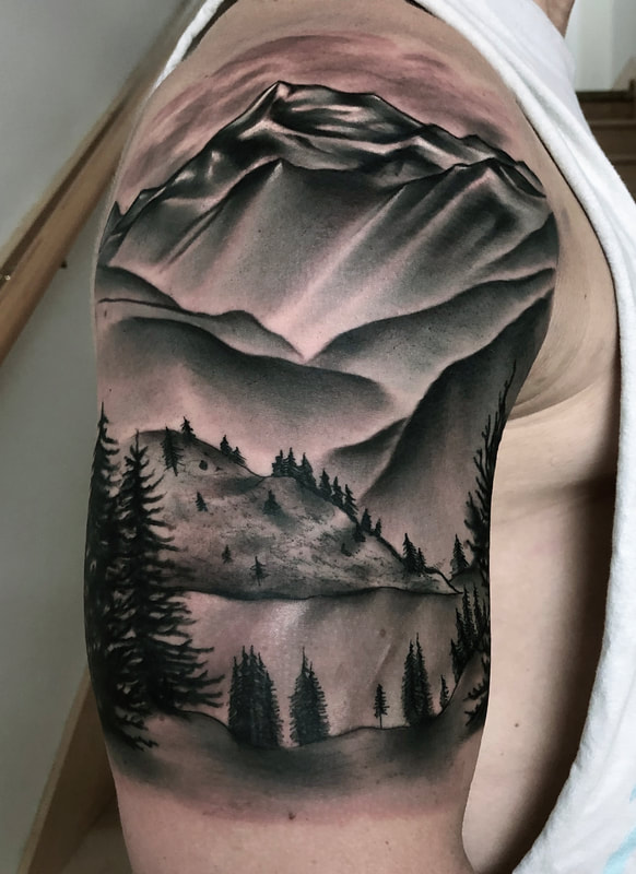 Realistic black and gray mountain and lake half sleeve tattoo.