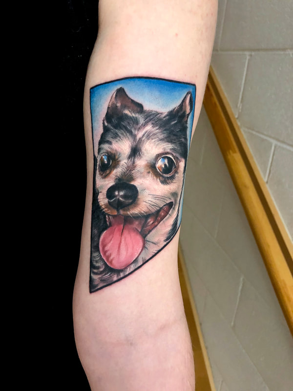 Realistic dog portrait tattoo.